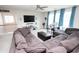 Living room with a large sectional sofa, TV, work desk and bright windows at 3406 Ravensworth Nw Trce, Kennesaw, GA 30144