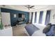 Comfortable primary bedroom with a ceiling fan, TV, and ample natural light at 3406 Ravensworth Nw Trce, Kennesaw, GA 30144
