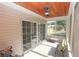 Screened porch with wood ceiling, ceiling fans, and sliding glass doors at 3406 Ravensworth Nw Trce, Kennesaw, GA 30144
