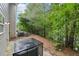 The backyard features a private setting surrounded by lush greenery and mature trees at 4001 Avalon Sw Rd, Atlanta, GA 30331