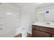 Clean bathroom featuring a shower-tub combo, spacious vanity, and contemporary fixtures at 4001 Avalon Sw Rd, Atlanta, GA 30331