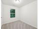 Bedroom with neutral carpet, white walls and window overlooking wooded area at 4001 Avalon Sw Rd, Atlanta, GA 30331