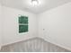 Bright bedroom features neutral carpet, white walls, and a window providing natural light at 4001 Avalon Sw Rd, Atlanta, GA 30331