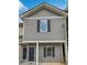 Exterior elevation of a gray townhouse with black shutters, showcasing modern architecture at 4001 Avalon Sw Rd, Atlanta, GA 30331