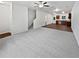 Spacious living room with modern ceiling fan, plush carpeting, and adjoining kitchen area at 4001 Avalon Sw Rd, Atlanta, GA 30331