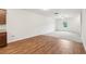 Open-concept living space with wood-look flooring, plush carpet, and adjacent kitchen area at 4001 Avalon Sw Rd, Atlanta, GA 30331
