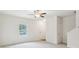 Bright living room with neutral carpeting, ceiling fan, and a large window at 4001 Avalon Sw Rd, Atlanta, GA 30331