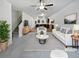 Bright living room with white sofa, striped rug, and open view into the kitchen and dining area at 4001 Avalon Sw Rd, Atlanta, GA 30331
