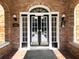 Inviting brick entrance with black double doors, side lights, and transom window above at 242 12Th Ne St # 8, Atlanta, GA 30309