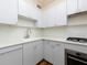 Close-up of kitchen with white cabinets, marble-look countertops, and stainless steel oven at 242 12Th Ne St # 8, Atlanta, GA 30309