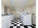 Shared laundry room featuring multiple washing machines and a black and white checkered floor at 242 12Th Ne St # 8, Atlanta, GA 30309