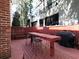 Private patio featuring wooden deck, tall table, built-in seating, and grill, great for outdoor living and entertaining at 242 12Th Ne St # 8, Atlanta, GA 30309