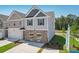 New construction townhome with gray and beige siding and a two-car garage at 133 Stanchion Dr, Union City, GA 30291