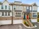 Modern townhome exterior with multiple levels, garage parking, brick accents and colorful doors at 370 Thrasher St # 2, Norcross, GA 30071
