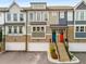 Modern townhome exterior featuring a colorful door and brick accents at 370 Thrasher St # 2, Norcross, GA 30071