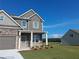 Beautiful two-story home with a lush green lawn and a detached structure in the background at 5994 Spring Way, Stonecrest, GA 30038