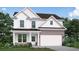 Charming two-story home with white siding, an attached garage, and a welcoming front porch at 5994 Spring Way, Stonecrest, GA 30038