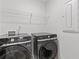 Laundry room with washer, dryer and shelving at 2966 Stockholm Way, Suwanee, GA 30024