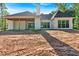 Rear exterior view showing modern farmhouse design with black window trim and covered patio at 107 Marks Way, Canton, GA 30115