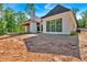 Rear exterior featuring black trimmed windows and an outdoor covered patio area at 107 Marks Way, Canton, GA 30115