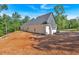 Side exterior showcasing board and batten siding and lush greenery at 107 Marks Way, Canton, GA 30115