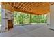 Large, covered patio with exposed wood beam ceiling, offering a serene outdoor living space at 107 Marks Way, Canton, GA 30115