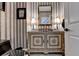 Stylish powder room with unique vanity and vertical striped wallpaper at 2230 Cammie Wages Rd, Dacula, GA 30019