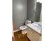 Cozy half bathroom with hard wood floors, updated fixtures, and a single sink vanity at 3370 Knighton Rdg, Powder Springs, GA 30127