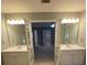 Bathroom featuring double sinks, and doors leading to a bedroom at 3370 Knighton Rdg, Powder Springs, GA 30127