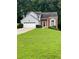 Charming split-level home with well-manicured lawn and two-car garage at 3370 Knighton Rdg, Powder Springs, GA 30127