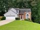 Charming split-level home with well-manicured lawn and two-car garage at 3370 Knighton Rdg, Powder Springs, GA 30127