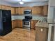 Well-lit kitchen with stainless steel appliances, light wood cabinets, and beautiful countertops at 3370 Knighton Rdg, Powder Springs, GA 30127