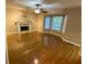 Cozy living room featuring hardwood floors, a fireplace, and large windows at 3370 Knighton Rdg, Powder Springs, GA 30127