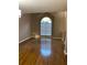 Bright living room featuring gleaming hardwood floors and a large window at 3370 Knighton Rdg, Powder Springs, GA 30127
