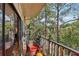 Relaxing balcony with wooded views and outdoor furniture at 27303 Plantation Ne Dr, Atlanta, GA 30324