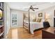 Bright bedroom with hardwood floors and a four-poster bed at 27303 Plantation Ne Dr, Atlanta, GA 30324