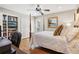 Comfortable bedroom with hardwood floors, built-in shelving, and a four-poster bed at 27303 Plantation Ne Dr, Atlanta, GA 30324