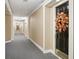 Well-lit hallway with carpeted floors and a decorative wreath at 27303 Plantation Ne Dr, Atlanta, GA 30324