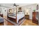 Spacious main bedroom with hardwood floors and a post bed at 27303 Plantation Ne Dr, Atlanta, GA 30324