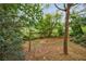 Wooded backyard with lush landscaping and privacy at 4599 Park Dr, Pine Lake, GA 30083