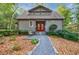 Craftsman style home with red door, gravel path, and manicured landscaping at 4599 Park Dr, Pine Lake, GA 30083