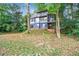 Modern two-story house with a screened porch and landscaped yard at 4599 Park Dr, Pine Lake, GA 30083