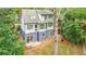 Two-story home with deck and surrounding trees at 4599 Park Dr, Pine Lake, GA 30083