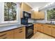 Updated kitchen with black appliances and light wood cabinets at 4599 Park Dr, Pine Lake, GA 30083