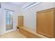 Mudroom with built-in bench, cabinets, and stained glass door at 4599 Park Dr, Pine Lake, GA 30083