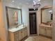 Elegant bathroom featuring double vanities, a walk-in shower, and decorative mirrors at 4853 Stonehall Pl, Atlanta, GA 30339