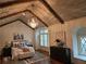 Spacious bedroom featuring wood ceiling beams, a decorative chandelier, and hardwood floors at 4853 Stonehall Pl, Atlanta, GA 30339