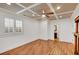 Spacious bedroom with hardwood floors, coffered ceiling, and window with shutters at 4853 Stonehall Pl, Atlanta, GA 30339