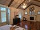 Luxurious bedroom boasts a vaulted ceiling, fireplace, and hardwood floors at 4853 Stonehall Pl, Atlanta, GA 30339