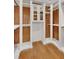 Spacious walk-in closet with custom shelves, rods and mirrored cabinets at 4853 Stonehall Pl, Atlanta, GA 30339